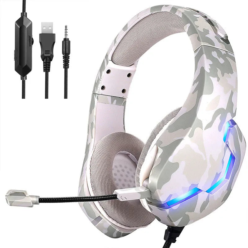 Wired camouflage gaming headset with cloth earmuffs and braided cable next to adapter