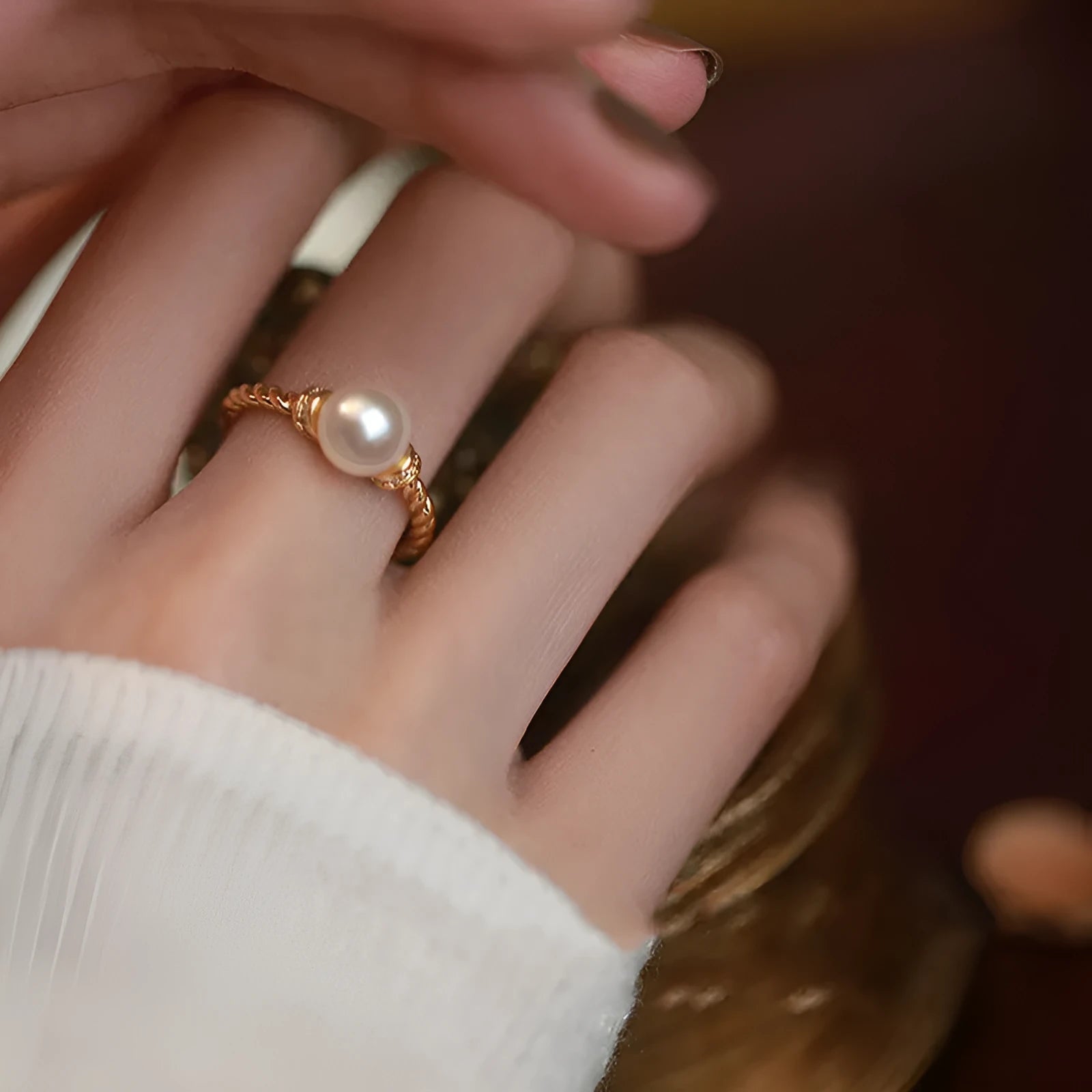 Geometric copper ring with antique twist design and pearl inlay, adjustable sizing shown