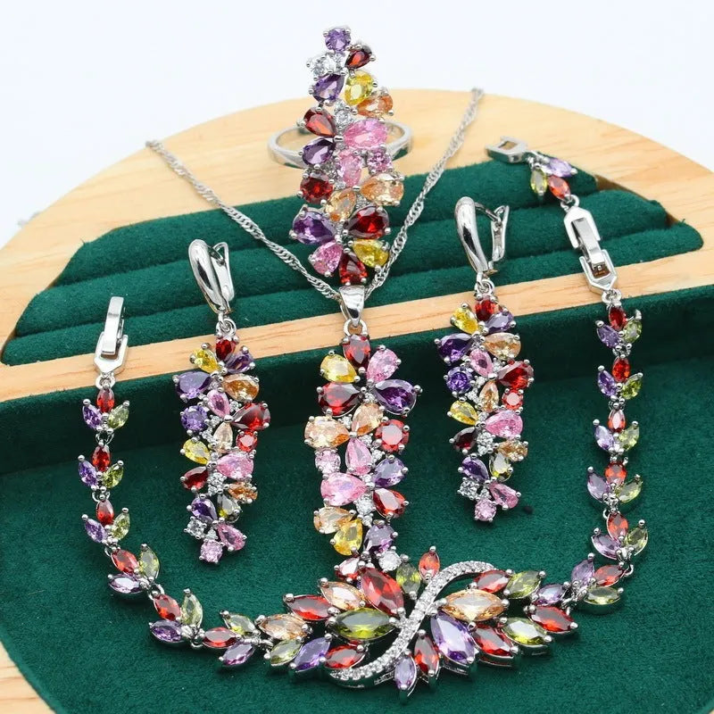 Retro botanical pattern jewellery set in copper alloy with zircon stones, showing necklace, bracelet, earrings, and ring.
