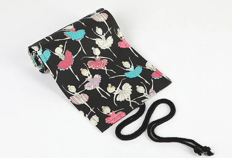 Square canvas rolling pencil case with ballet girl print, showing multiple pencil slots inside.