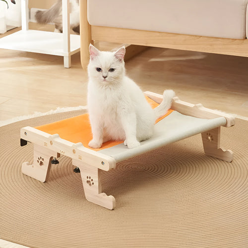 Wooden cat hanging bed hammock mounted on a balcony railing