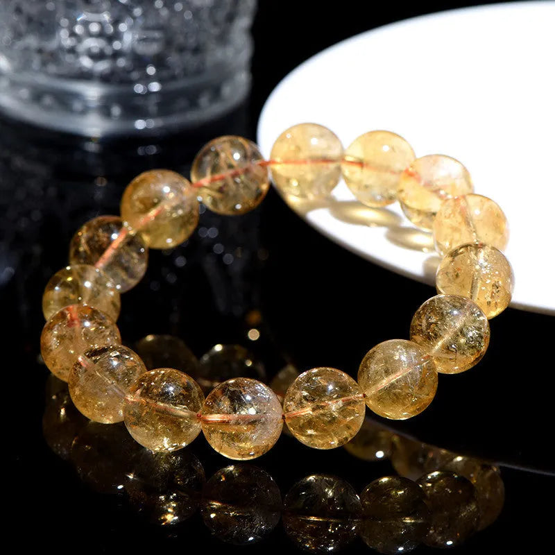 Natural yellow citrine gemstone bead bracelet showing geometrical beads on a string.
