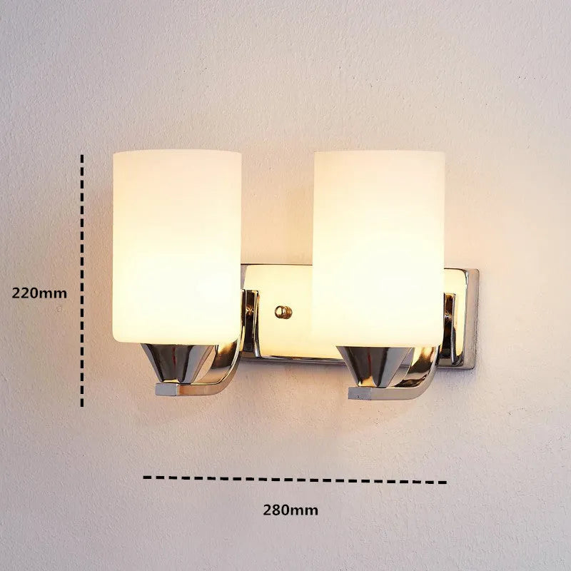 Modern chrome wall lamp with glass lampshade in single head configuration on white wall