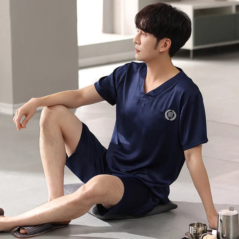 Man's ice silk short-sleeve pyjama shirt and shorts set in a loose, comfortable fit on a hanger