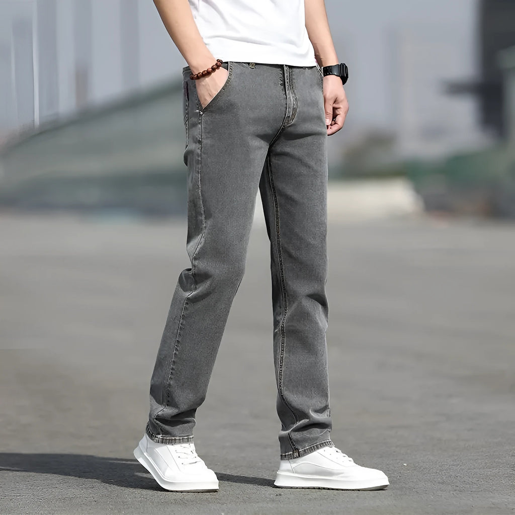 Men's smoky gray jeans with straight leg cut and rabbit fur fabric showing zip fly closure