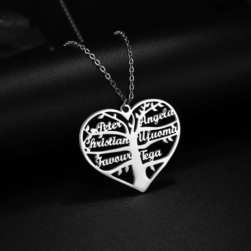 Women's custom name necklace with stainless steel heart and tree pendant on a chain.