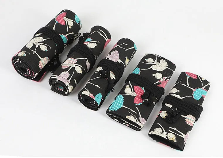 Square canvas rolling pencil case with ballet girl print, showing multiple pencil slots inside.
