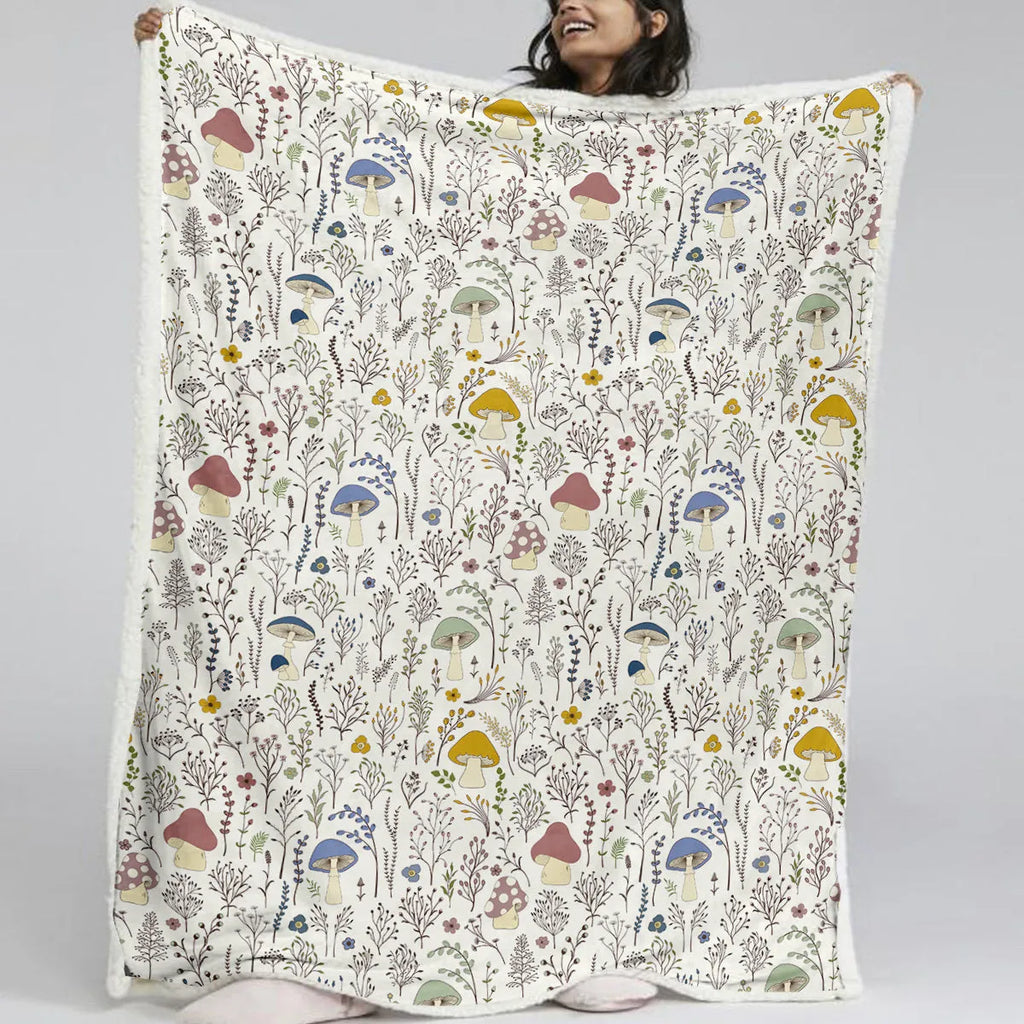 White Sherpa fleece blanket with tree leaf mushroom pattern, sized 130x150cm, on a sofa