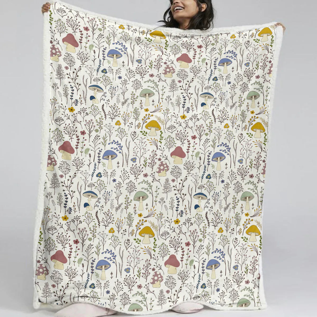 White Sherpa fleece blanket with tree leaf mushroom pattern, sized 130x150cm, on a sofa