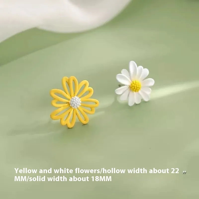 A pair of cartoon-style flower stud earrings in alloy, shown in a two-tone colour option.