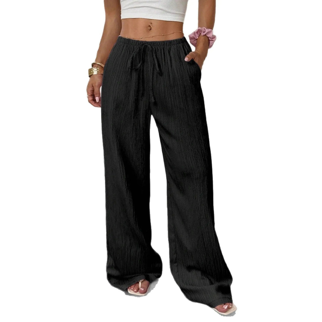 Women's black wide leg trousers with lace-up waist detail, shown with pink colour option