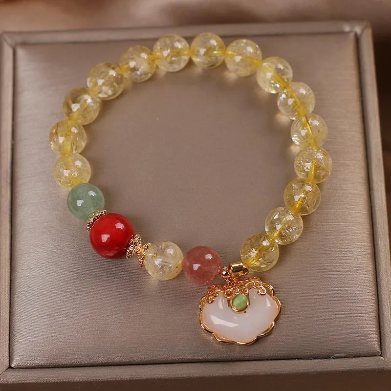 Women's yellow hair crystal jade Ruyi pendant on an alloy bracelet.