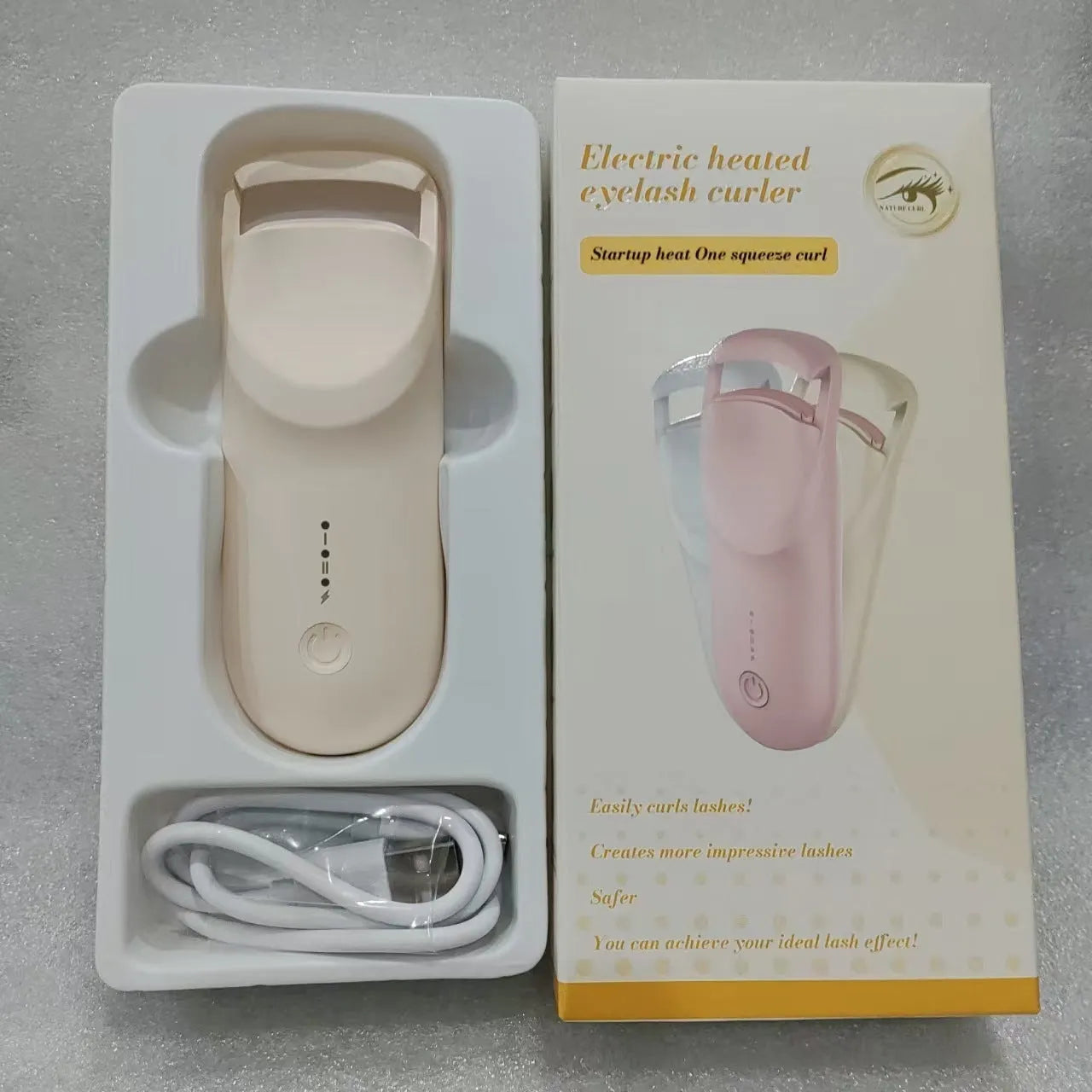 USB-rechargeable electric heating eyelash curler in cream white colour with cable