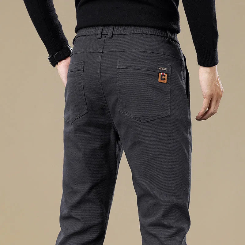 Men's fleece-lined slim fit tapered casual cotton trousers in black, shown flat for detail