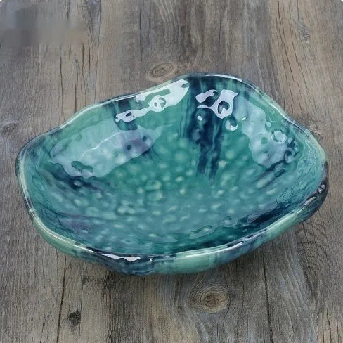 Japanese ceramic sashimi bowl with irregular shape and floral decoration pattern