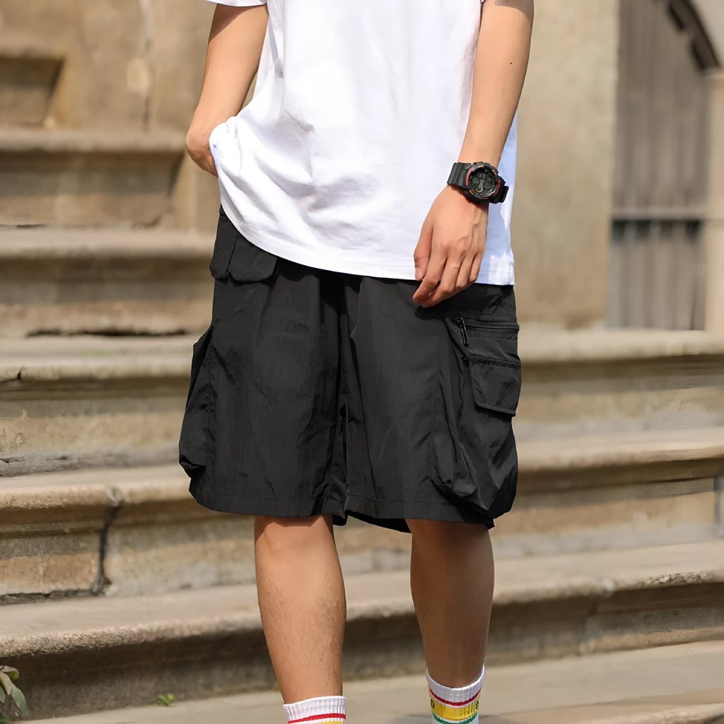 Men's mid-waist cargo shorts in solid green colour made from polyester