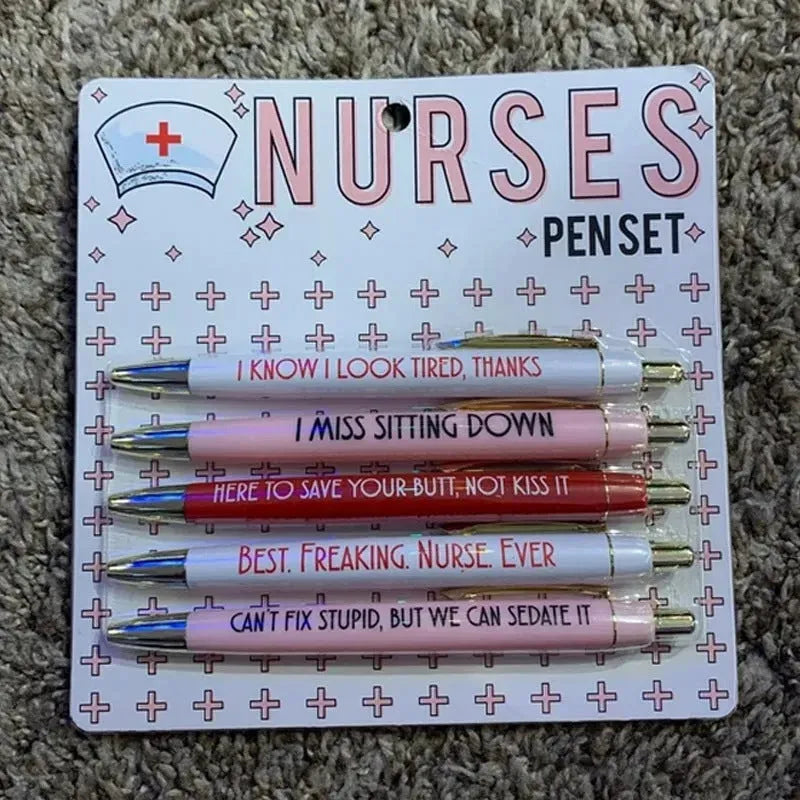 Five nurse-themed retractable ballpoint pens laid out, showing humorous medical designs.