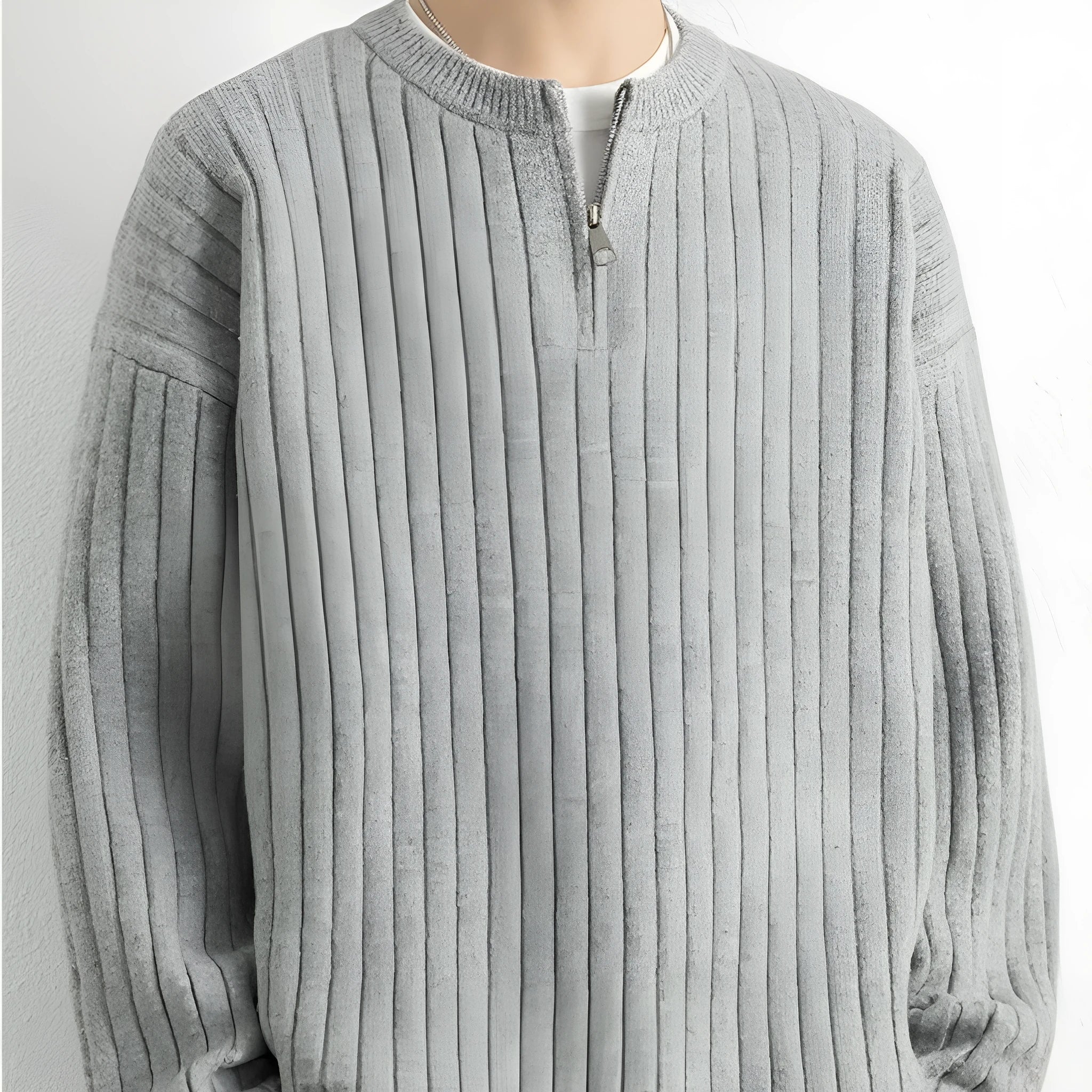 Men's grey loose fit half-zip pullover sweater with textured knit and long sleeves.