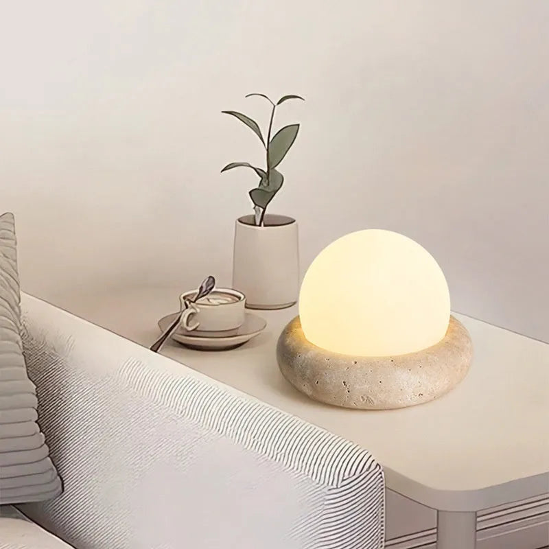 Cream modern bedside table lamp with remote control on wooden surface