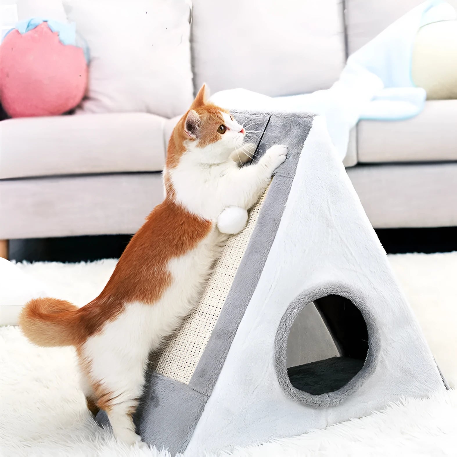 A grey and white triangular cat toy with a sisal scratching side and a soft plush bed.