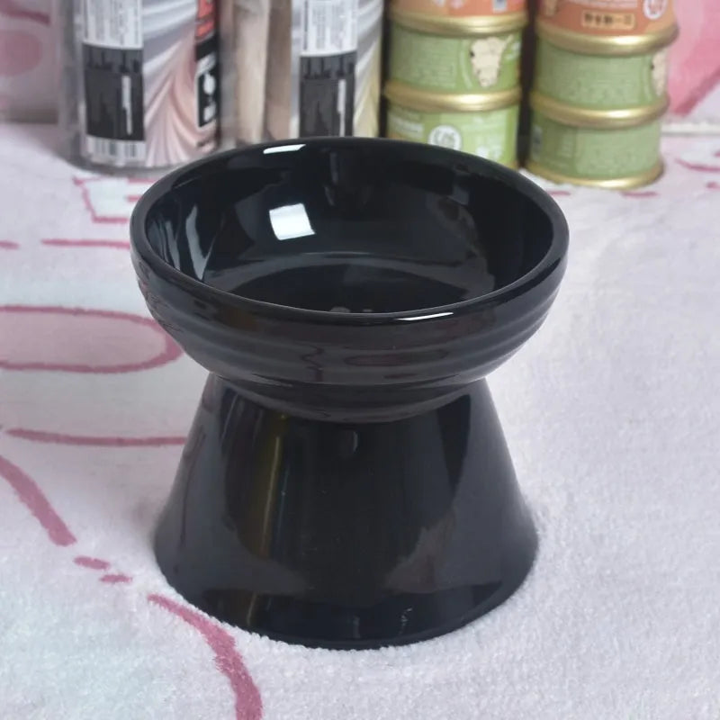 Black ceramic pet bowl with a raised foot and high neck guard for dogs and cats.