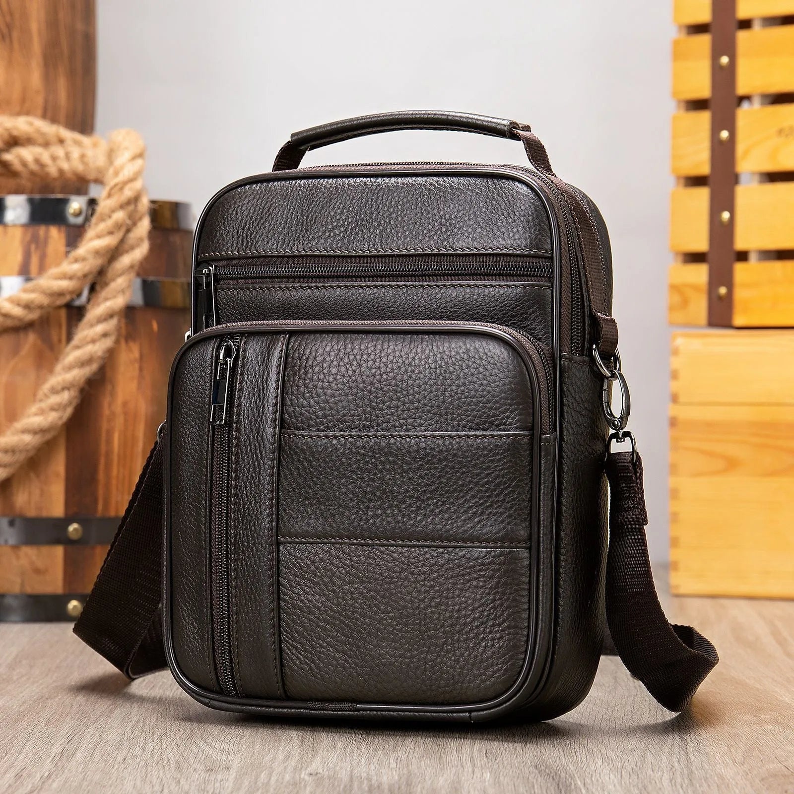 Men's vintage brown genuine cowhide leather vertical square shoulder bag with a zipper.