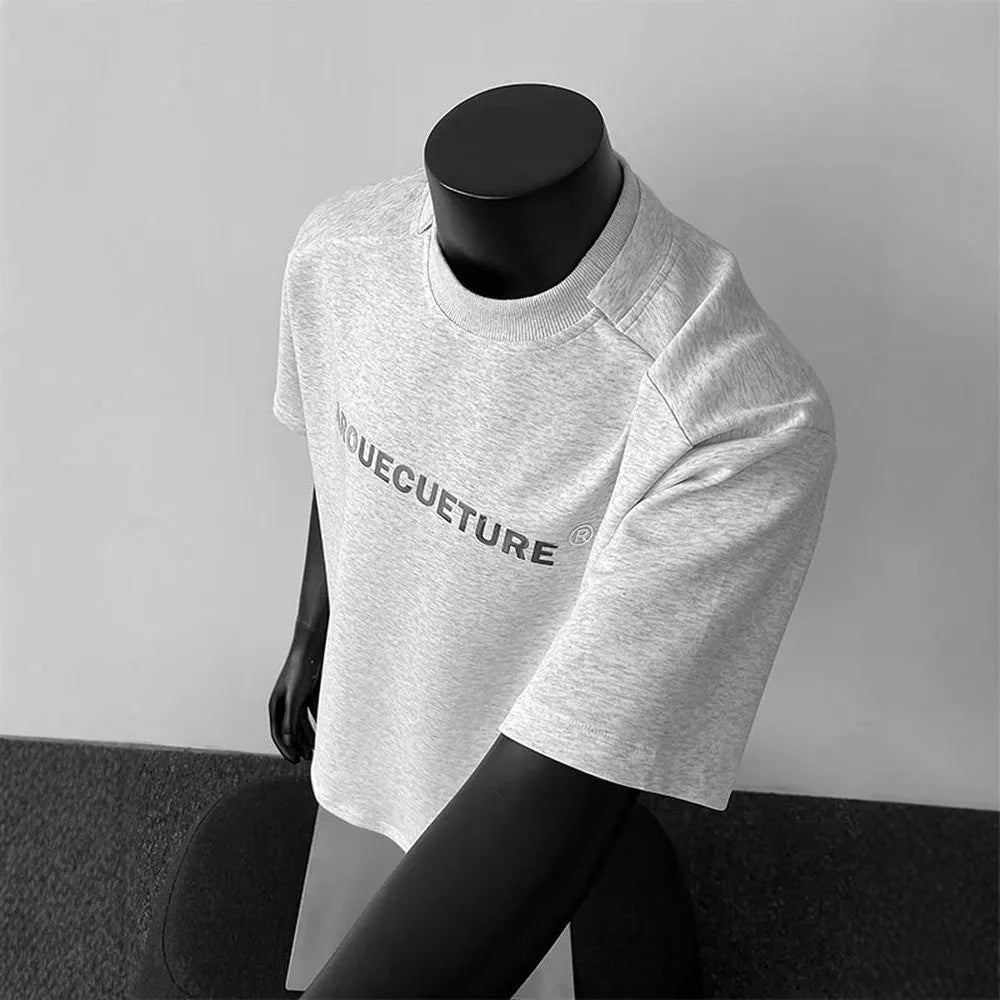 Men's plain black short sleeve cotton pullover shirt on a hanger, loose fit.