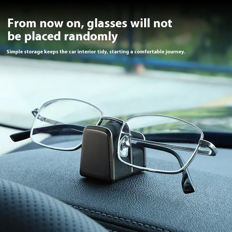 Green zinc alloy and leather glasses clip holder mounted on a car dashboard.