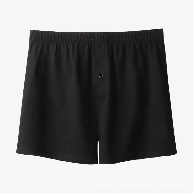 Men's solid-colour pure cotton boxer shorts with a high-waist and loose fit on a plain background.