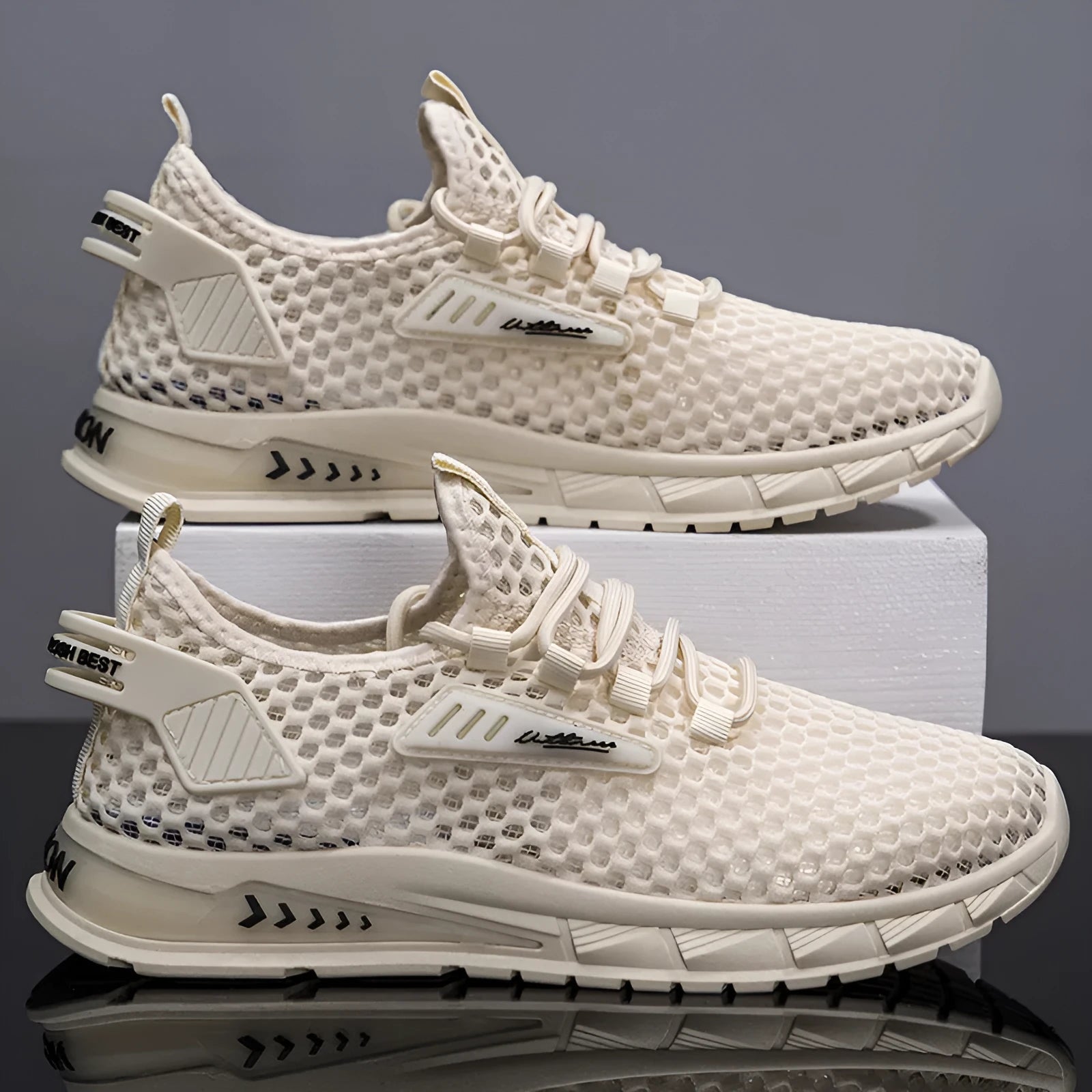 Men's beige lace-up sneakers with synthetic leather upper and mesh panels on a white background.