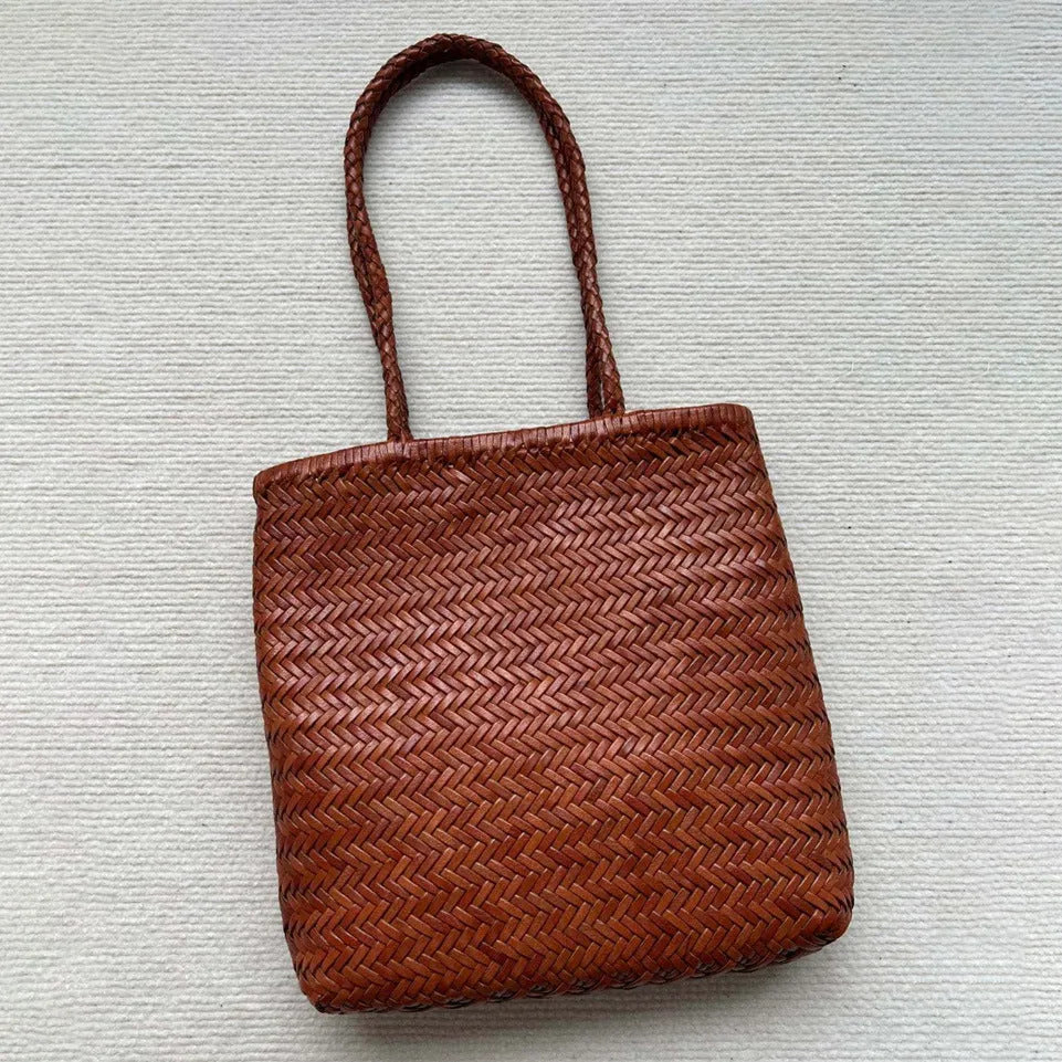 Brown handmade cowhide leather shoulder bag with woven tote design and three-dimensional pocket