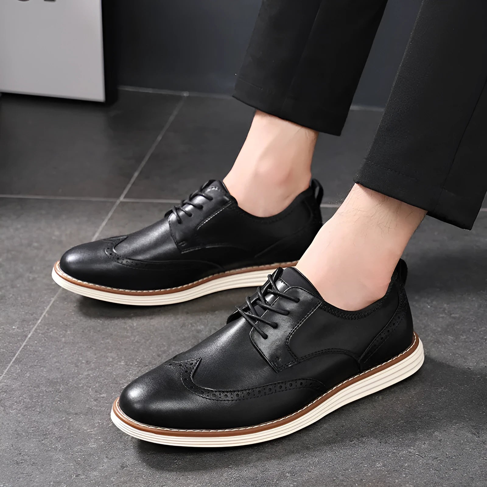 Men's black slip-on business casual shoes with decorative carved detailing and TPR soles