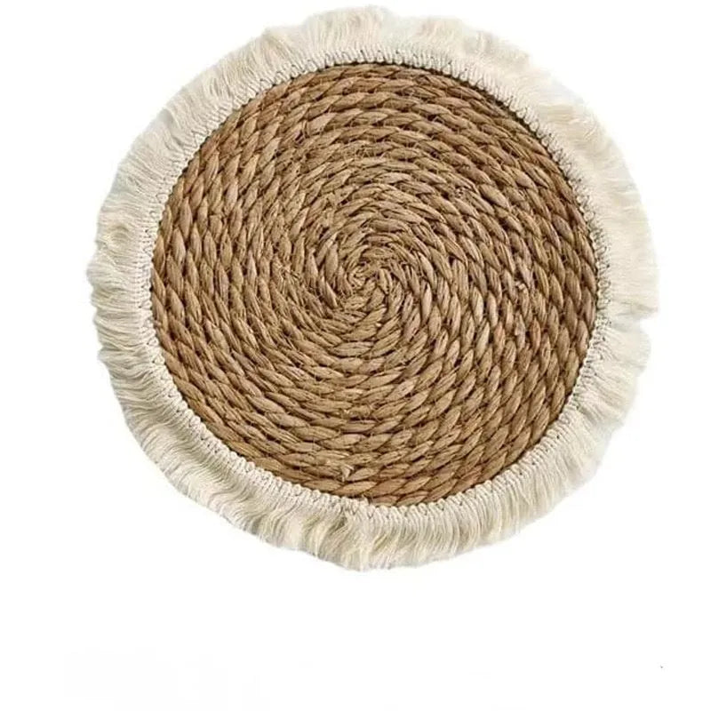 Round natural papyrus placemat with decorative tassels on a wooden table, shown in various sizes.