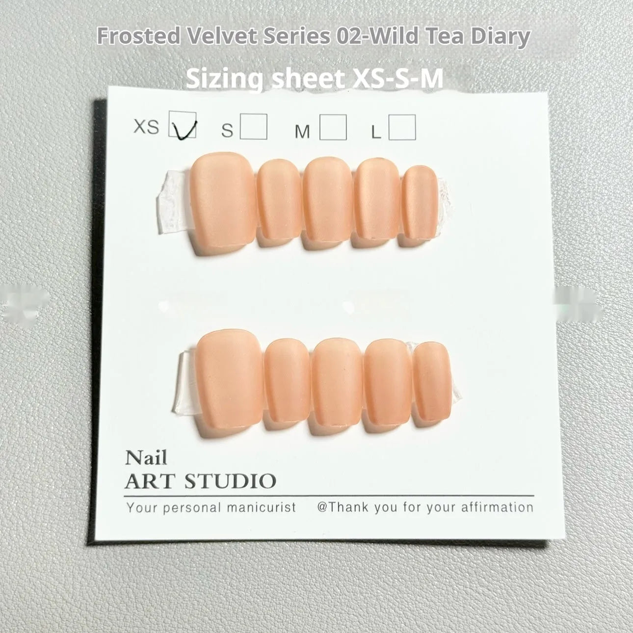 Frosted Velvet Cat's Eye false nail set with Aurora design on a clear background, showing short ladder sizes.