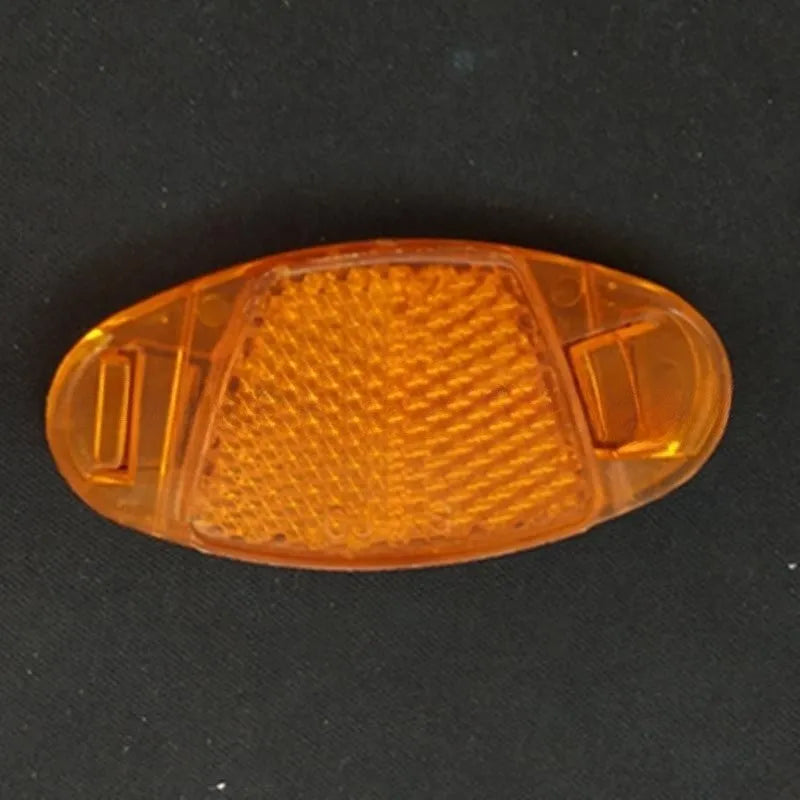 White and yellow plastic bicycle spoke reflectors measuring 7.2cm by 3.5cm for safety visibility