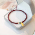 Red rope hand-woven bracelet with crystal centrepiece and adjustable wristband