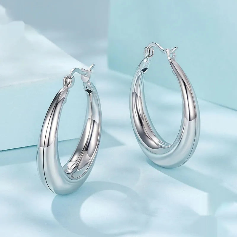 Women's geometric ring ear clip earrings in copper with silver needle detailing