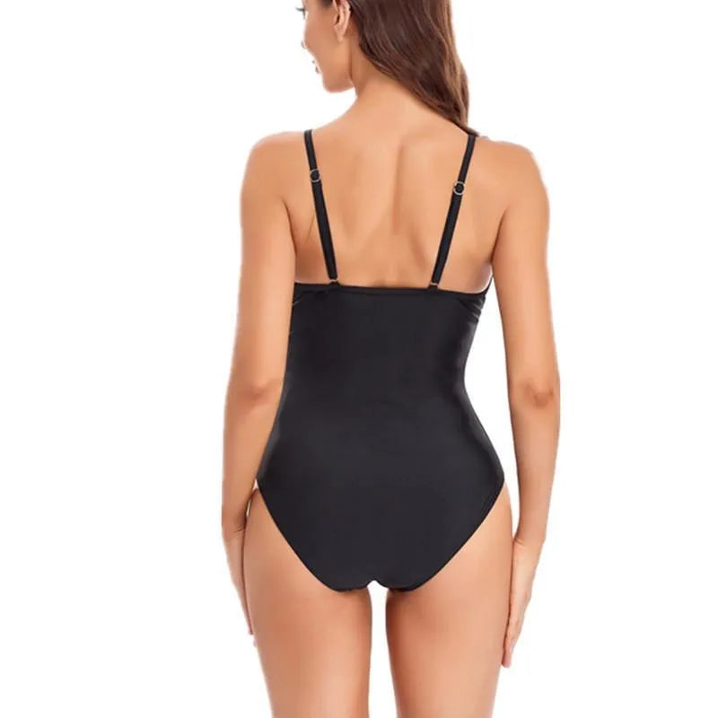 Black backless one-piece swimsuit laid flat showing solid colour and high-elasticity fabric.