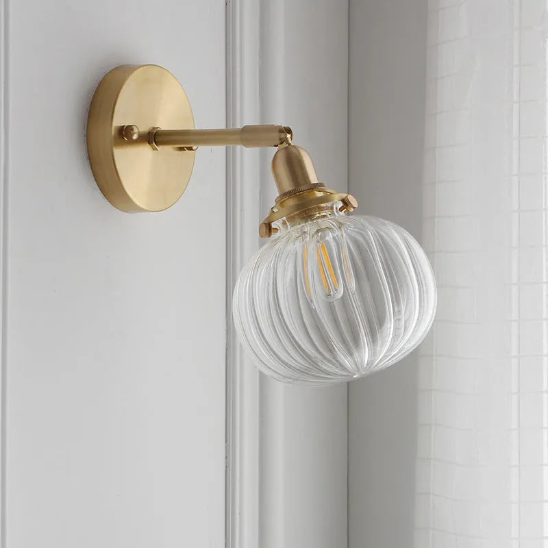 Pumpkin-shaped glass wall lamp in a choice of blue, clear, or water ripple transparent finish.
