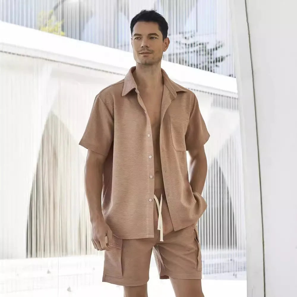 Plain grey polyester two-piece set with short sleeve top and elastic waist shorts laid flat.