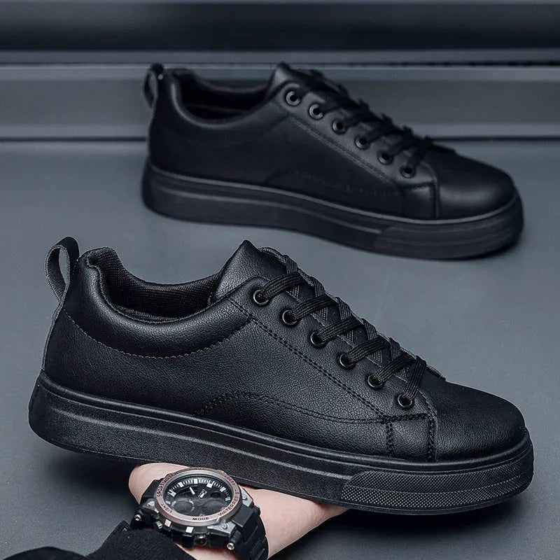 Men's white and black Korean-style low-top casual sneakers with round toe and flat heel.