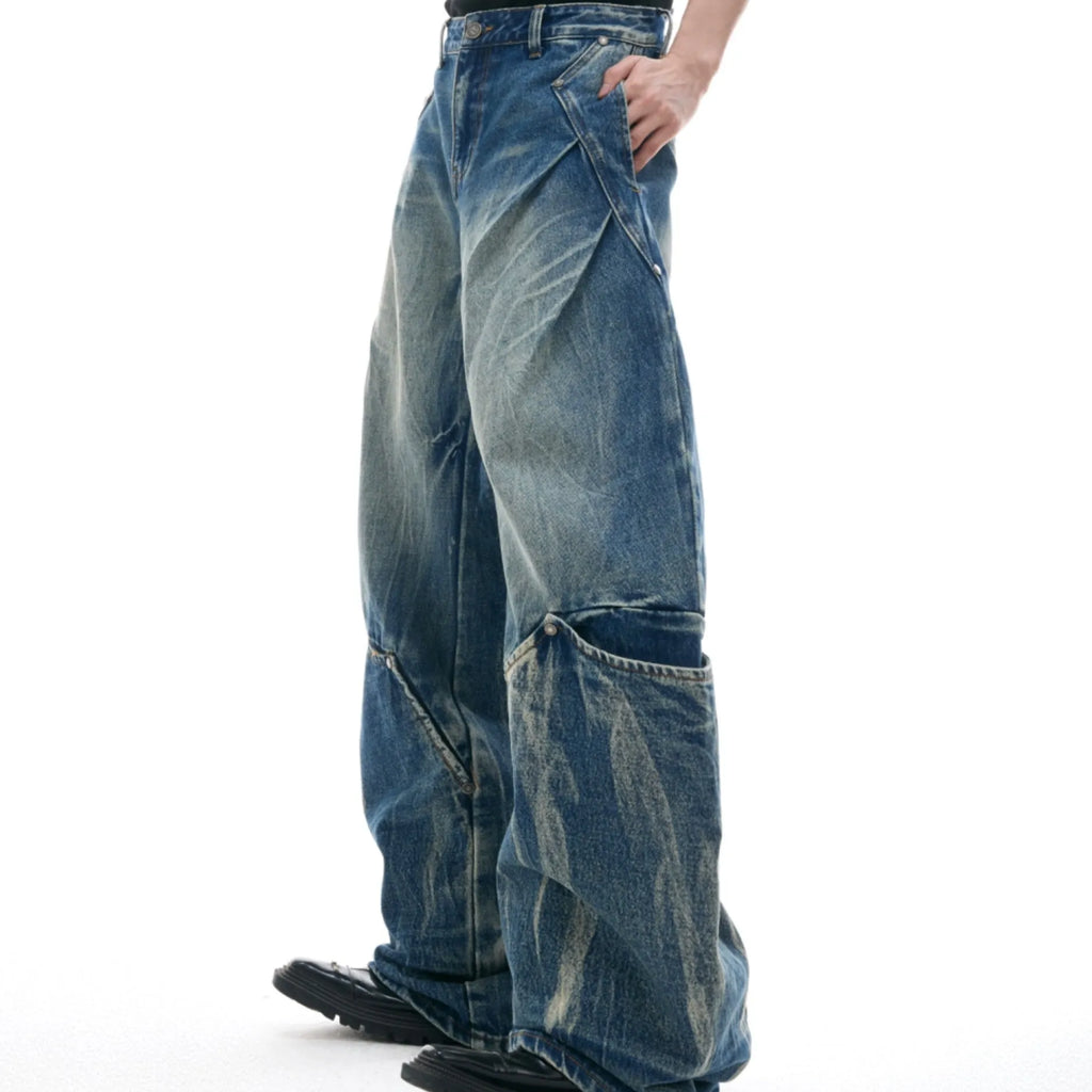 Men's verdant blue loose-fit jeans with a retro washed burst pattern and curved knife leg detail.