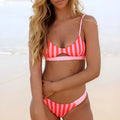Women's bikini swimsuit in polyester, showing black and white dots and red and white stripe colour options.