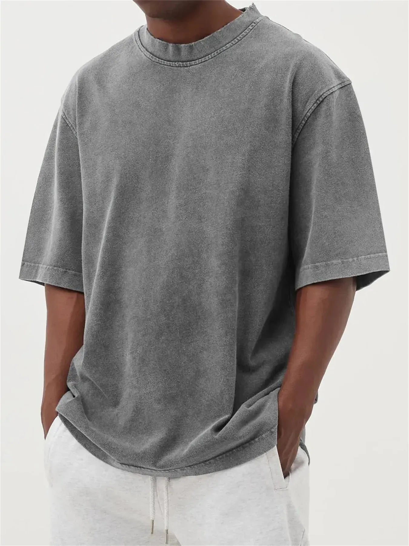 Men's loose-fit stone-washed t-shirt in army green showing distressed texture and pullover style.