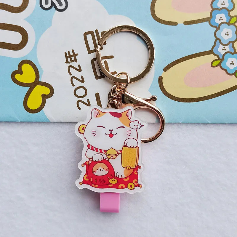 Lucky Cat blessing certificate set showing plastic card sleeve and ferrule pendant in cartoon style.