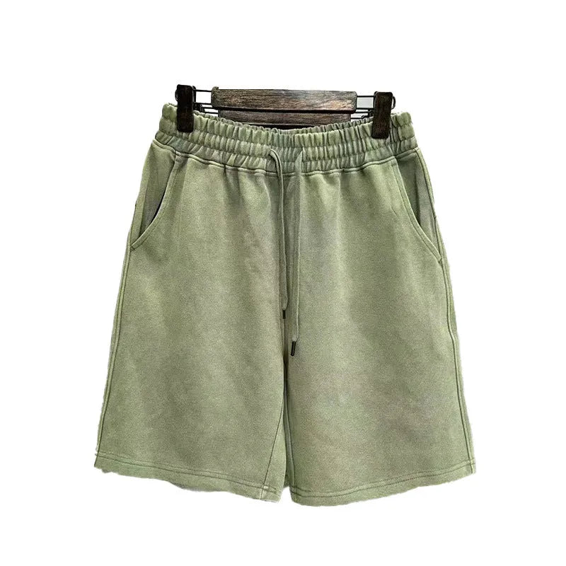 Men's light blue cotton shorts with distressed detailing and a loose, straight-leg fit on a mannequin.