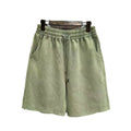 Men's light blue cotton shorts with distressed detailing and a loose, straight-leg fit on a mannequin.