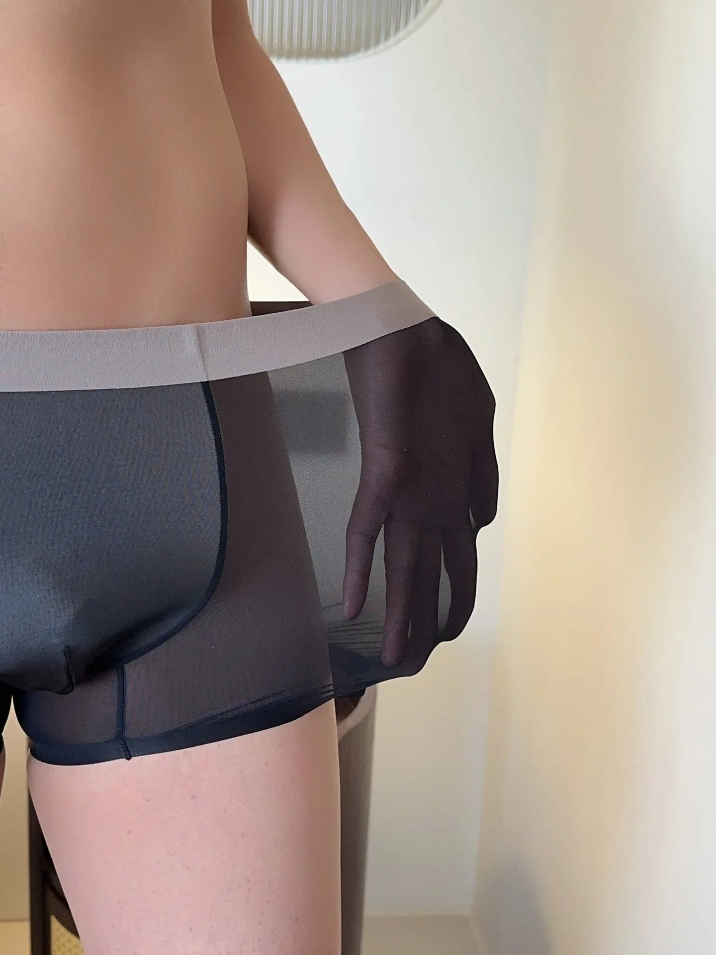 Men's seamless antibacterial boxer shorts in ice silk fabric showing honeycomb crotch detail.