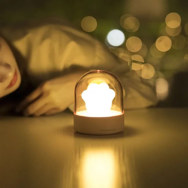 Grey cat paw shaped USB rechargeable night light with rotating musical display