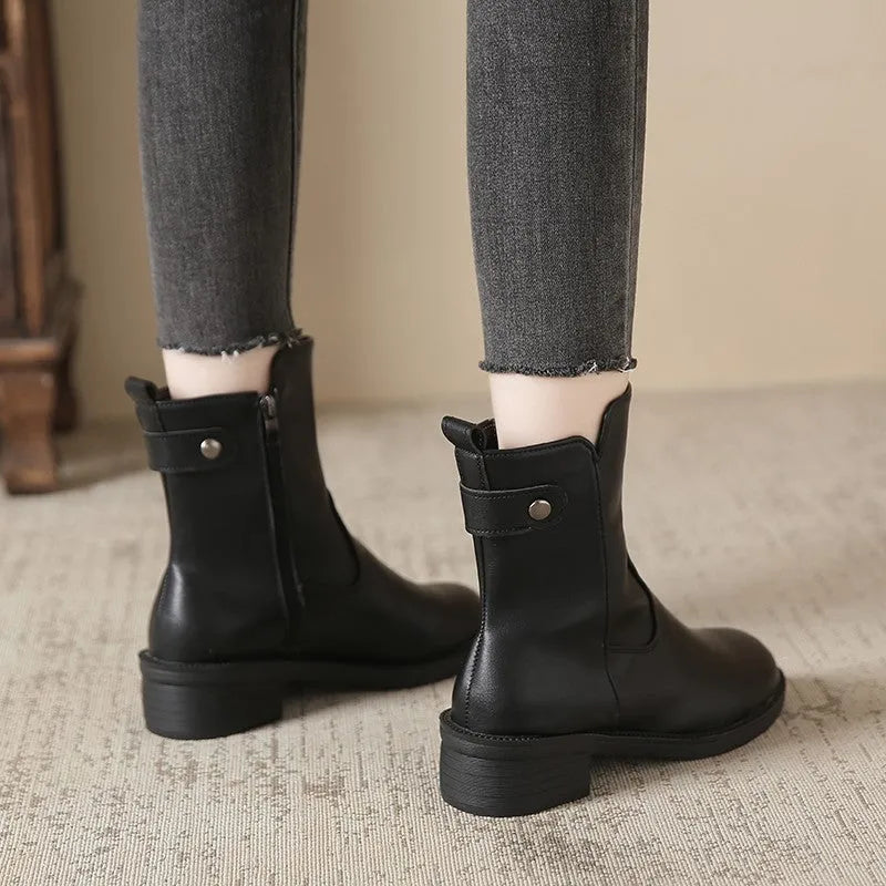 Black women's short boots with a low round toe and side zip, shown on a white background.